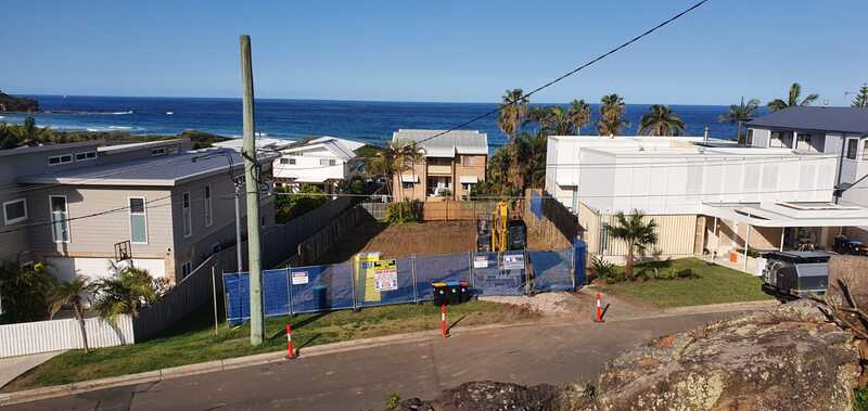 View across a cleared and fenced residential site towards the coast